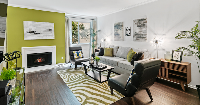 Modern living room with fireplace, plants and curated accessories