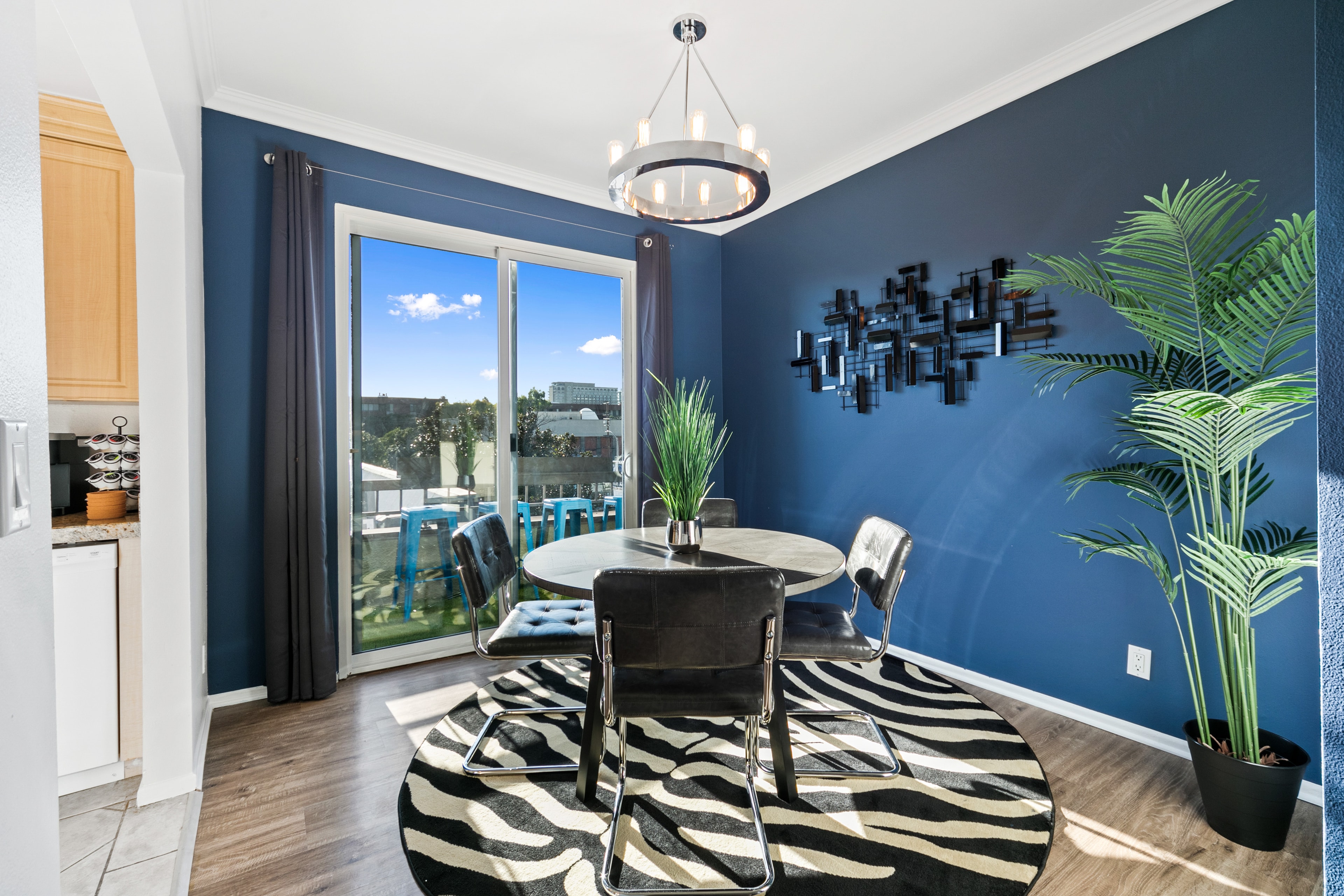 Dining room with cobalt-blue walls, modern table, and plants