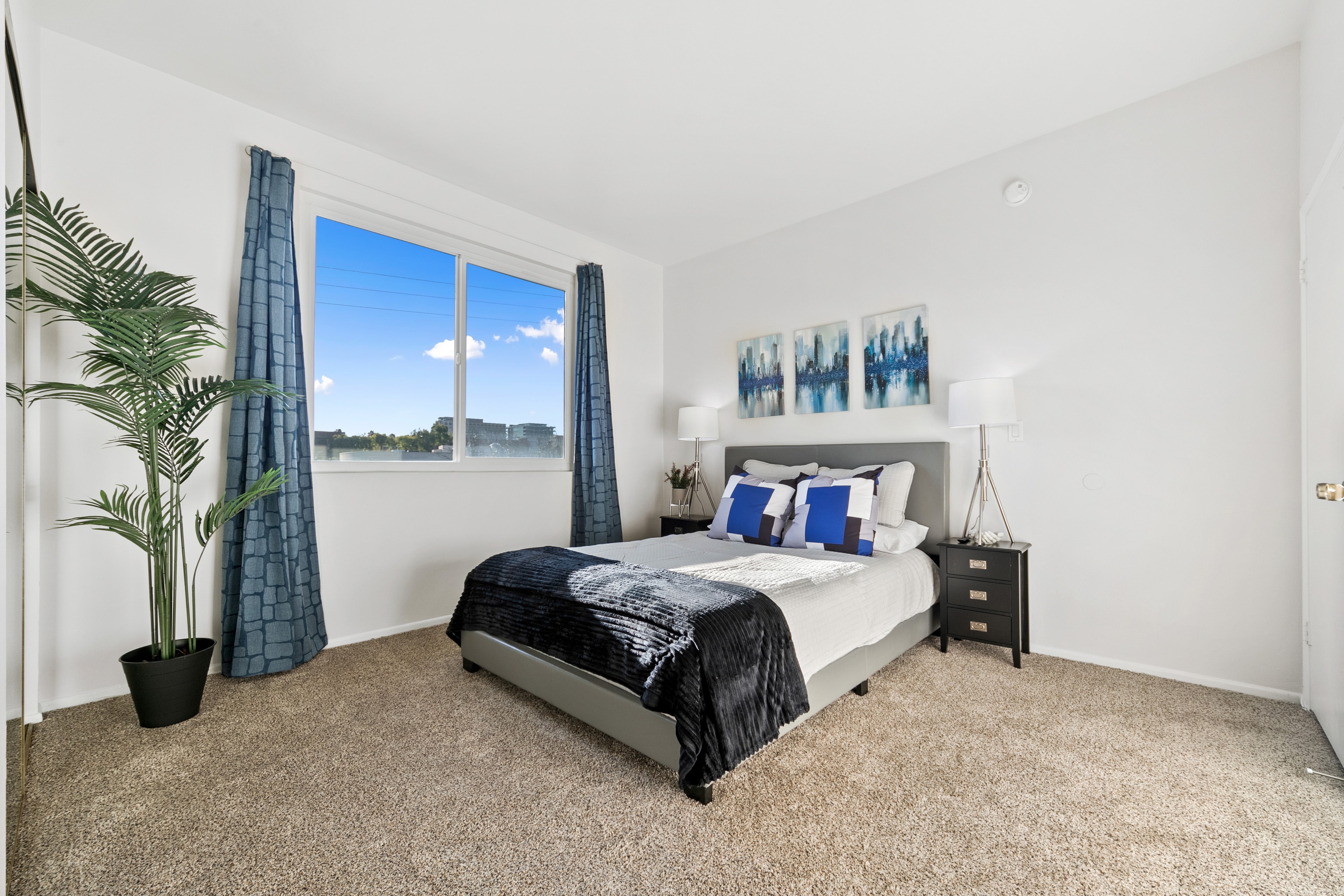 Second bedroom with cobalt-blue accents and a bright window