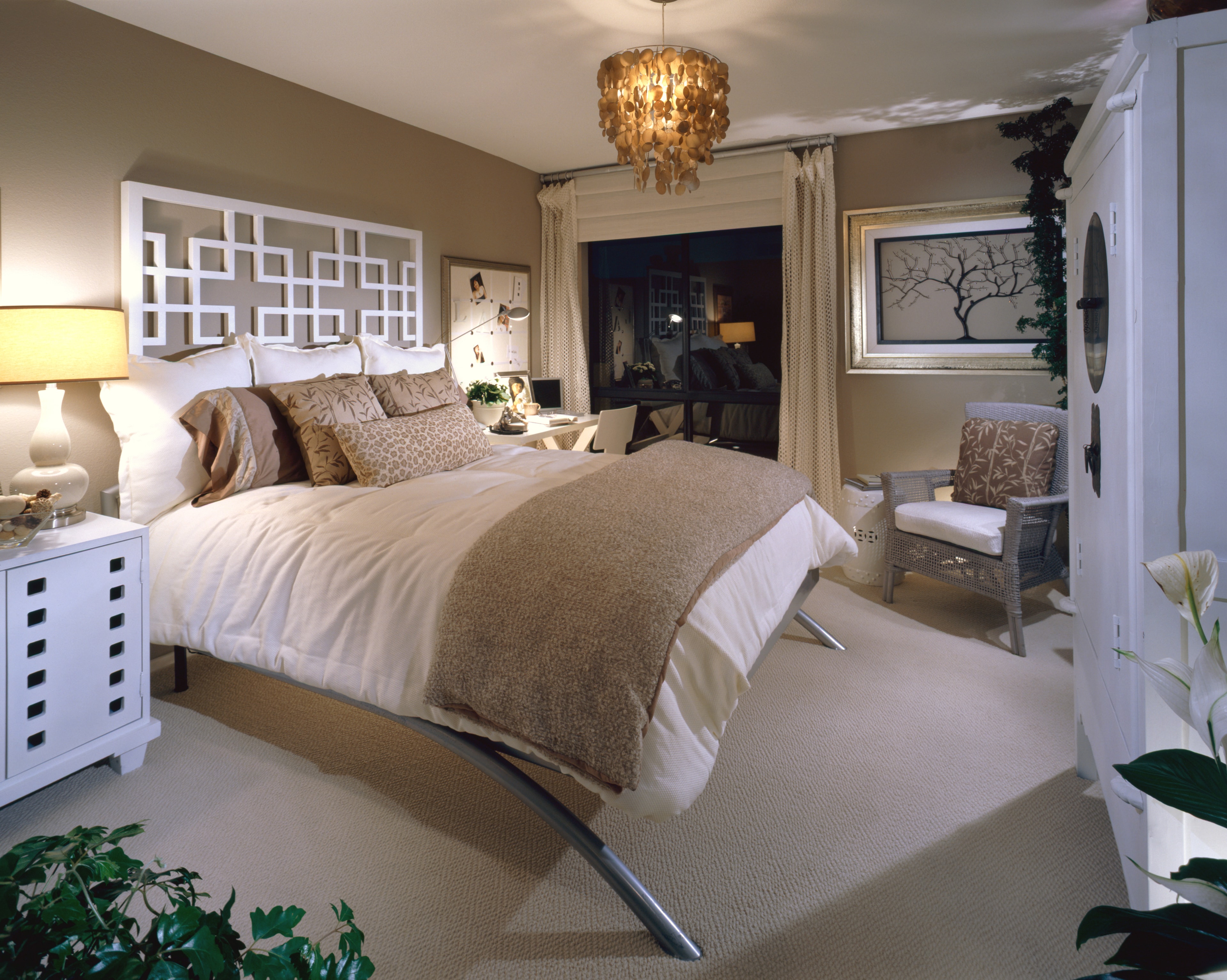 Secondary bedroom with warm neutral bedding, woven textures, and natural accents