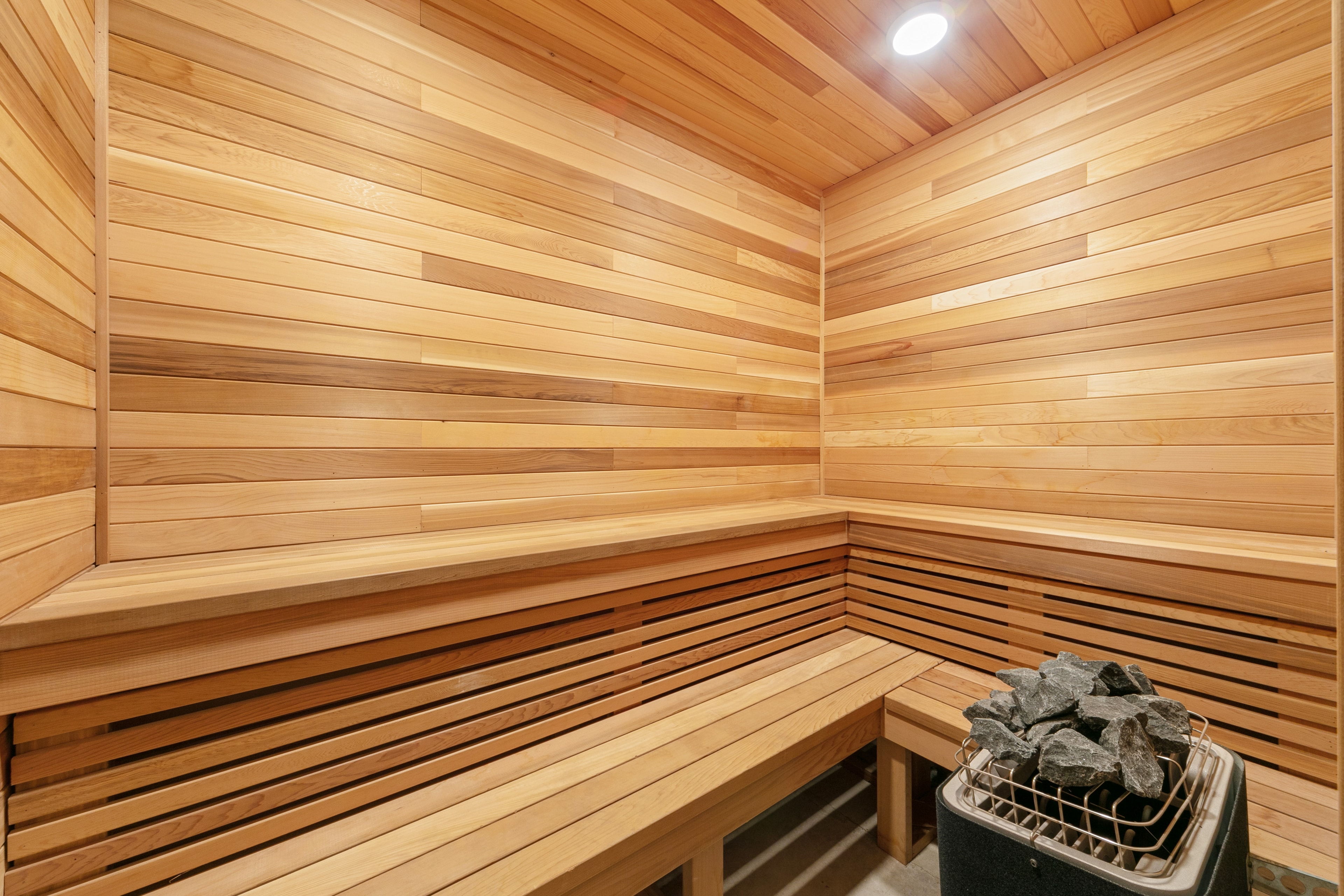 Warm wood-paneled sauna with tiered benches