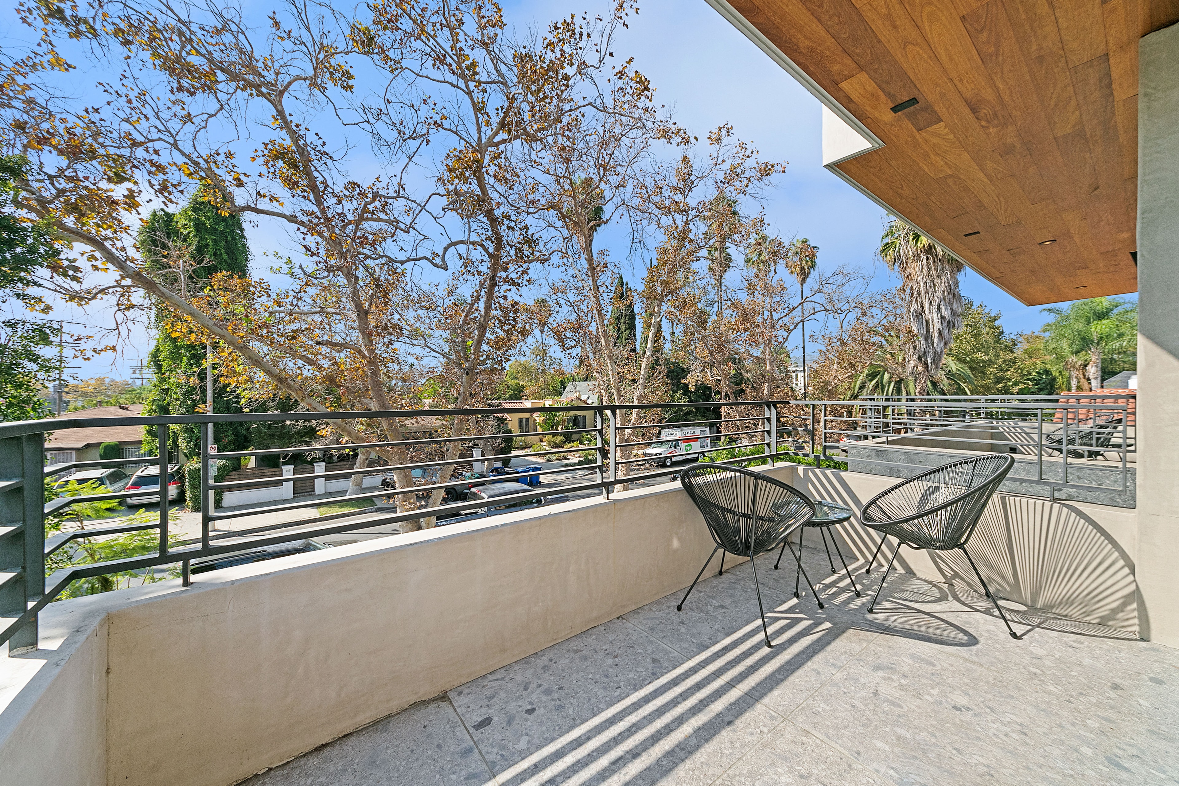 Furnished upstairs balcony overlooking a leafy Los Angeles street