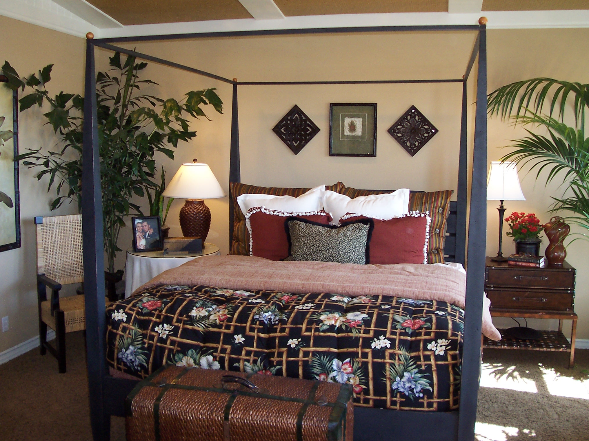Four-poster bedroom with patterned bedding and warm wood furnishings