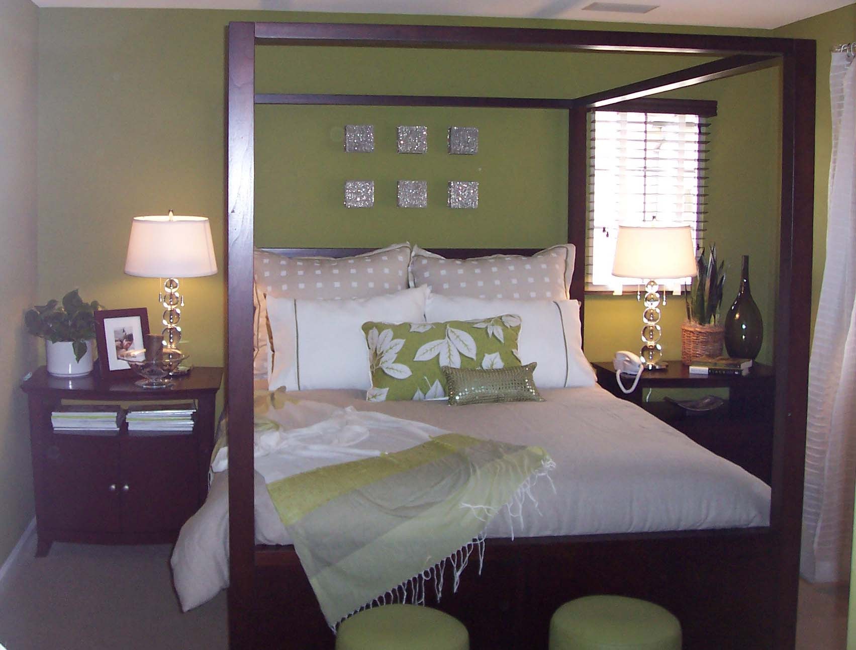 Olive green bedroom with a dark wood canopy bed