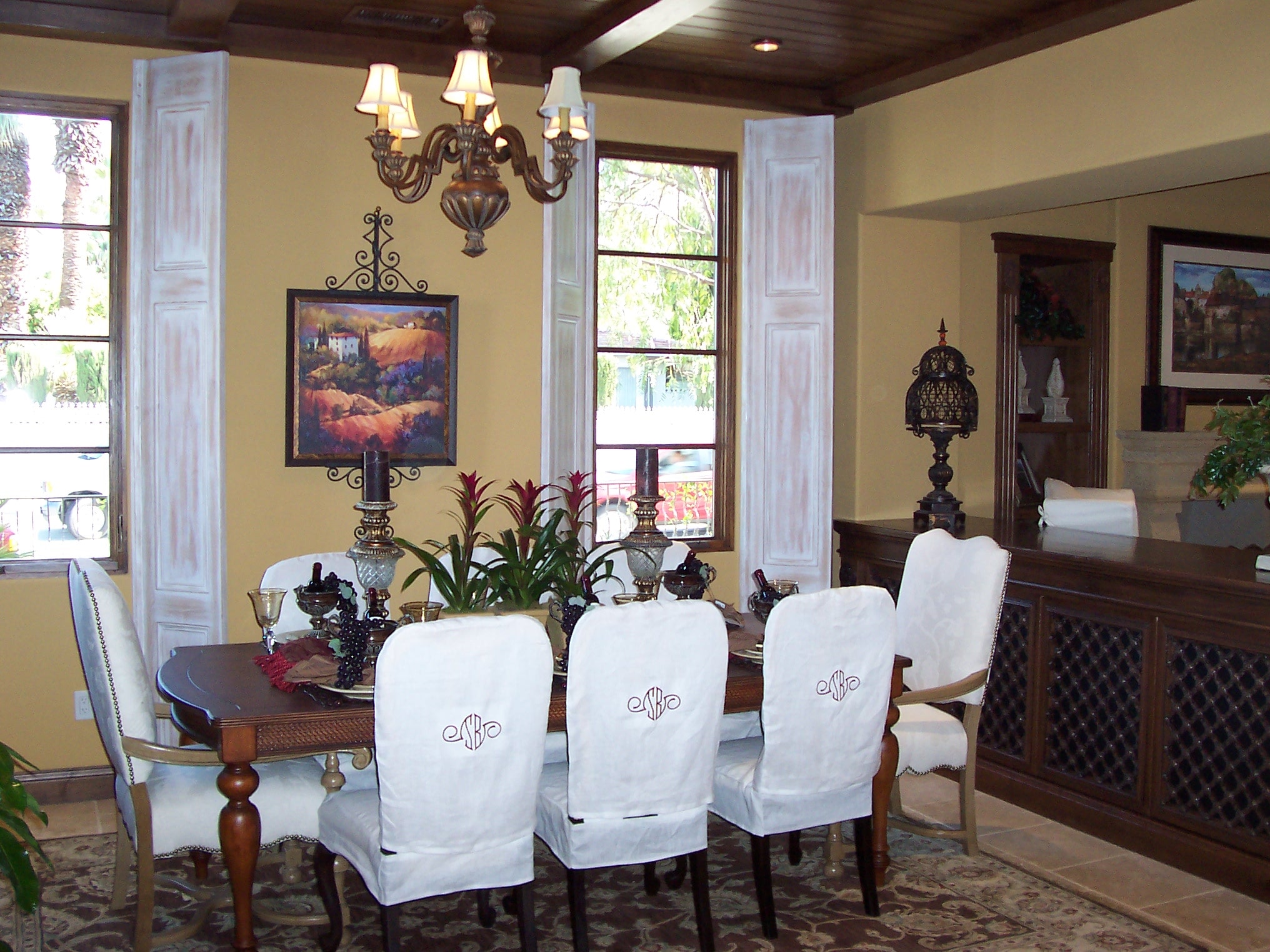 Traditional dining room with white slipcovered chairs and dark wood table
