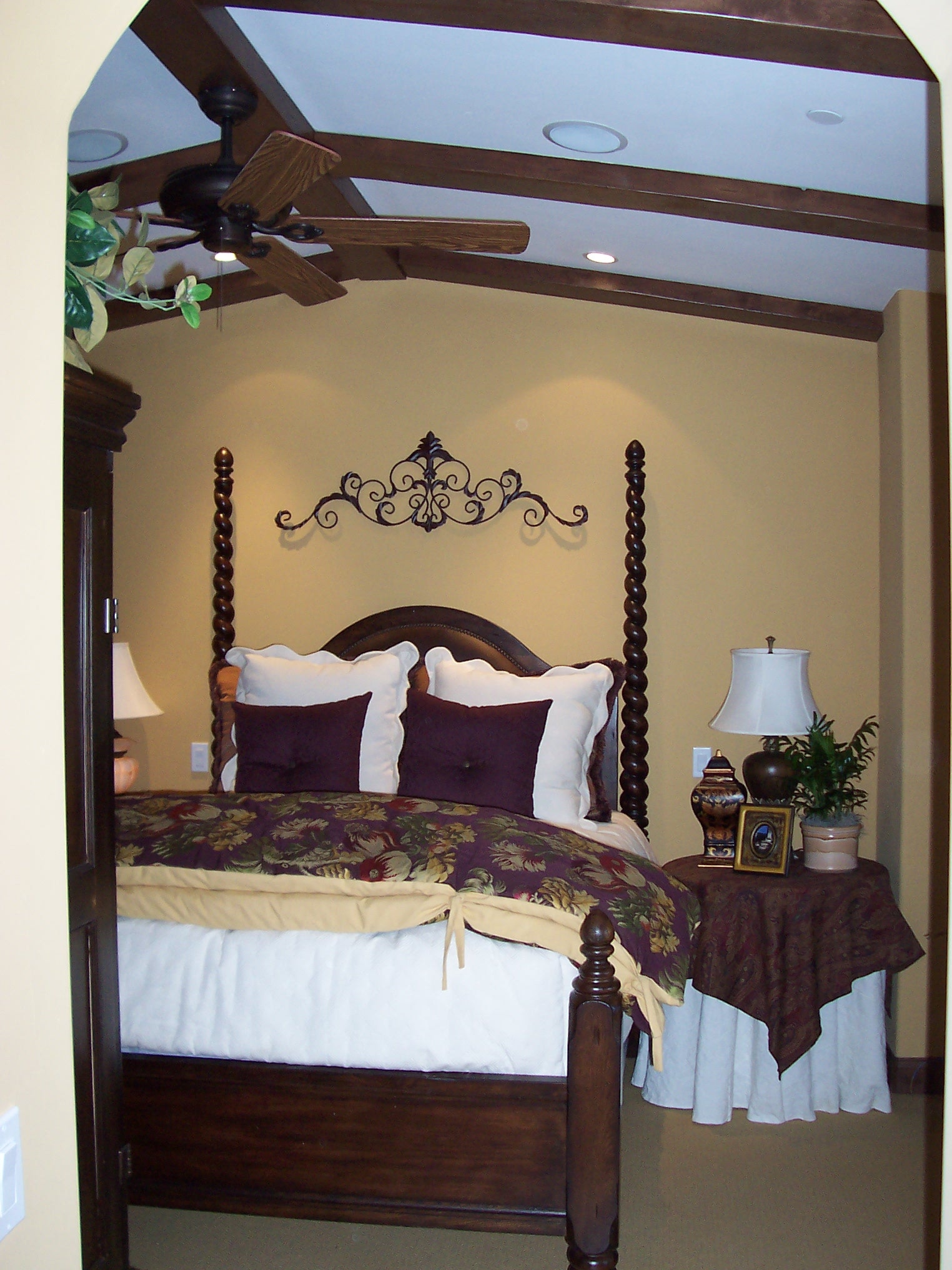 Traditional bedroom with dark wood four-poster bed and ceiling beams