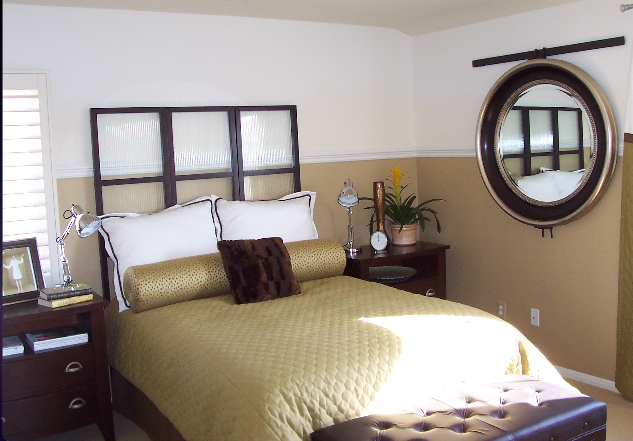 Bedroom with upholstered bench and warm neutral palette