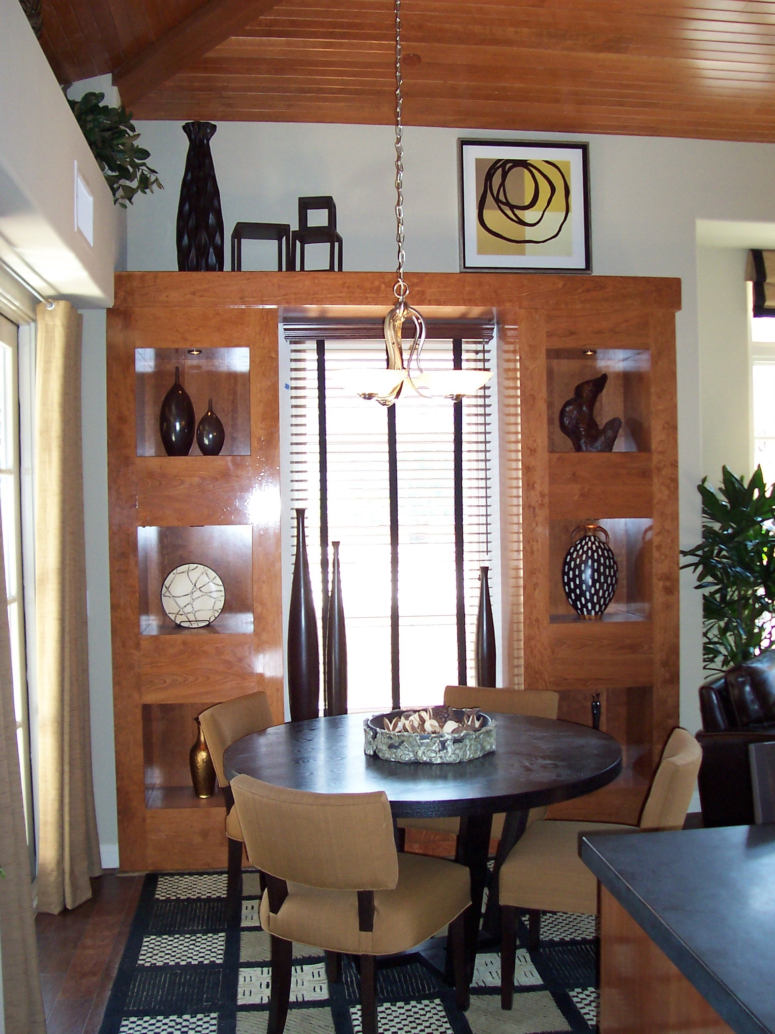 Dining room with custom wood built-in display wall